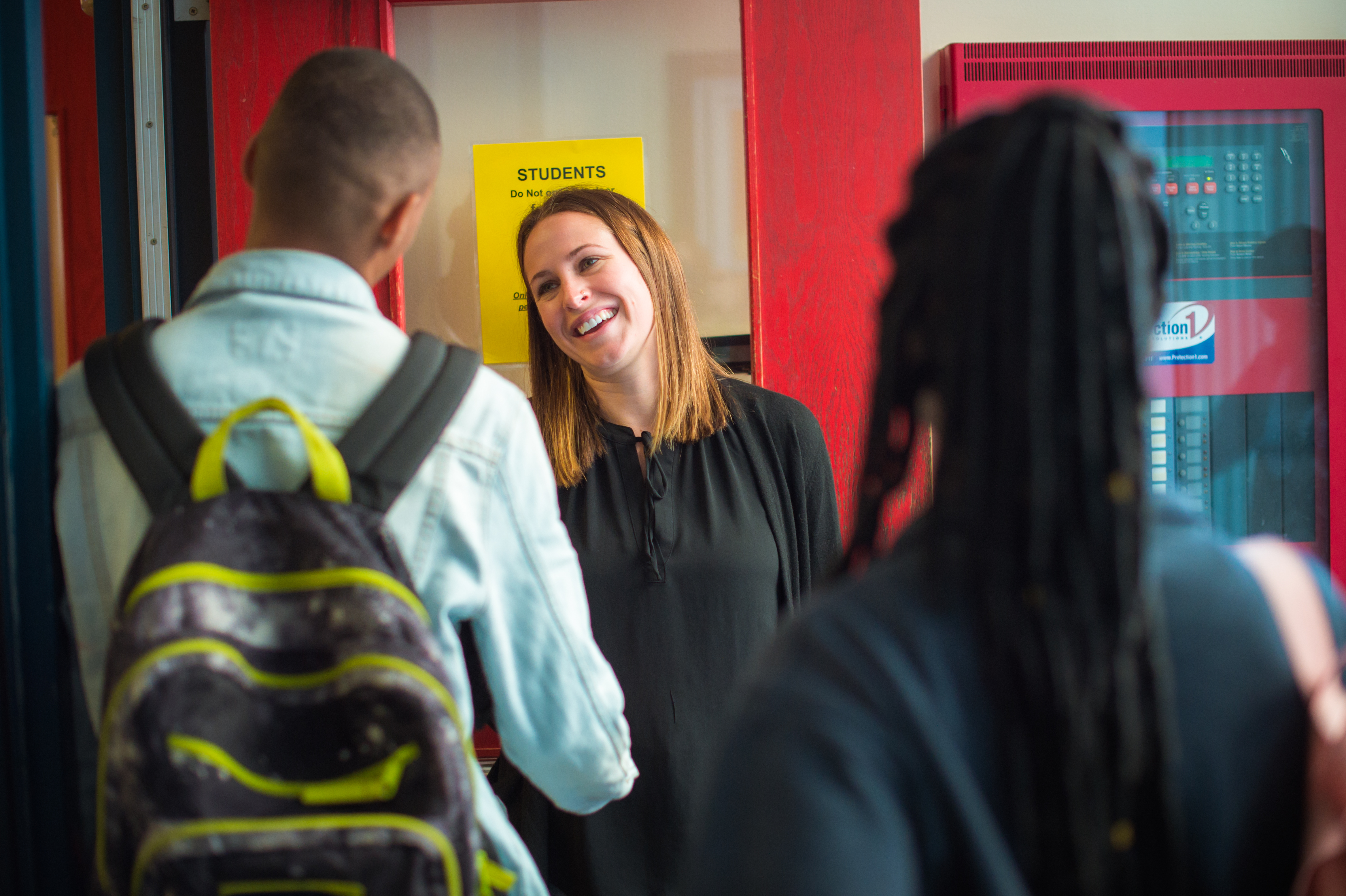 Teaching shaking students hands as they walk into class